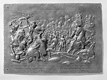 An ancient battle scene in metal relief
