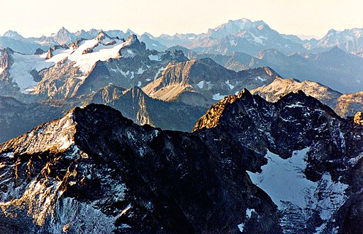 Mt. Benzarino in lower half of frame, seen from Black Peak. Note small glacier below summit. (McGregor Mountain in upper left)