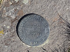 Survey marker at the summit of Breccia Peak.