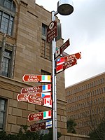 photo of signpost with ten signs pointing in the direction of Phoenix's sister cities, stating their names and distances from Phoenix.