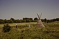 Visitors taking photos next to a tipi