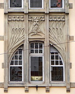 Irises and mascaron at the façade of Schichtel building in Strasbourg, France, by Aloys Walter (1905–06)