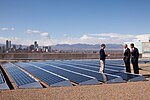 Barack Obama speaks with CEO of Namaste Solar Electric, Inc., Blake Jones, while looking at solar panels in Denver, Col., 2009