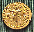 Three-faced four-armed Oesho with attributes, often identified with Shiva, on a coin of Huvishka.[60]