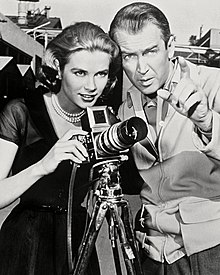 A black and white publicity photo of Grace Kelly and James Stewart for Rear Window