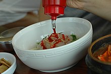 Gochujang is usually added to the top of hoedeopbap
