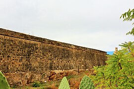 Northern curtain wall elevated on rock. In the background the Espantaperros Tower