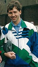 A photograph of Bryan Robson in a white, green and blue tracksuit.