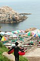 haenyeo carrying baskets toward the sea in Ulsan