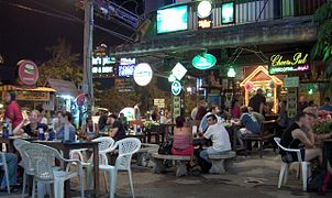 Tourists sit outside a bar in Chiang Mai, Thailand