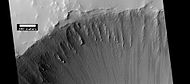 Crater at the top of Ulysses Patera, as seen by HiRISE under HiWish program Note the lack of a rim. Volcanic craters do not usually have a rim, as most impact craters do.
