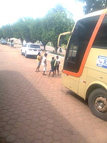 Children standing in front of a bus