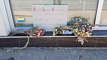 Flowers placed in front of a closed shop. A handwritten sign reads "Hello Loved Customers, We are sad to inform you that we will no longer open for business due to the legislations placed on dispensaries"