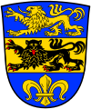 Landkreis Dillingen a.d.Donau Unter blauem Schildhaupt, darin ein schreitender goldener Löwe, geteilt von Gold und Blau; oben ein schreitender, herschauender, rot bewehrter schwarzer Löwe unten eine goldene Lilie.