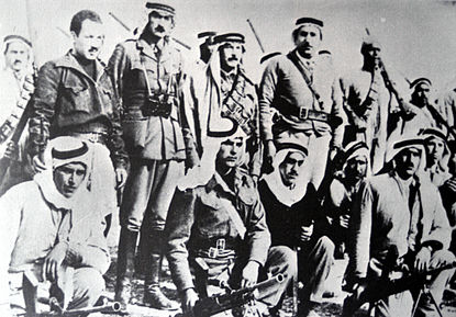 Abd al-Qadir al-Husayni returned to Palestine after an exile of ten years, and began organizing Arab resistance to forcible partition of the country. He is seen here (standing center) with aides and Palestinian irregulars, Jerusalem district, February 1948