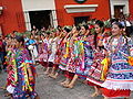 Oaxacan women on parade in traditional apparel.