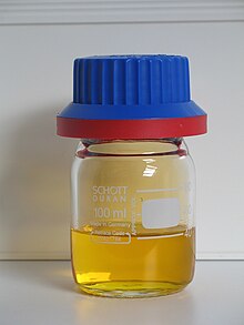 a vial containing some clear golden-brown liquid
