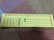 An abacus that uses colored sliders instead of beads. Red represents the value 5; green represents the value 1. The value in the abacus is 4025.