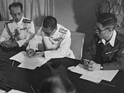 A Japanese Navy officer signing the surrender of Penang aboard HMS Nelson on 2 September 1945. Penang was liberated by the Royal Marines on the following day under Operation Jurist.