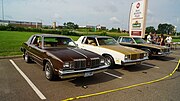 1979 Cutlass Supreme Coupe next to a pair of Hurst/Olds W-30's from the same year.