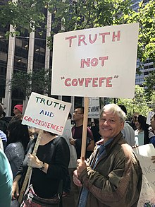 Protester holding a 'Truth not "Covfefe"' sign.