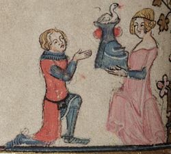 A knight in red receiving a helmet from a damsel in pink, from an English manuscript of The Romance of Alexander (1338-1344).