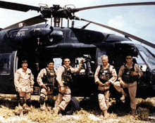 Soldiers in front of helicopter