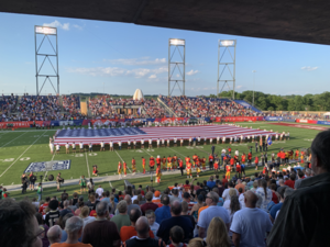 The flag of the United States displayed on a football field before the start of the game.