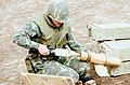 Fuzed 81mm white phosphorus mortar shell in 1980. Note spelling of "fuze" on adjacent boxes