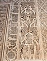 Arabesque and pine cone motifs along with Kufic inscriptions around the Ben Youssef Madrasa's mihrab, in Marrakesh