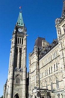 A tall, stone brick tower with a large clock