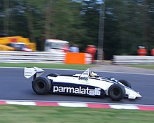A mid-engined single-seater racing car with large aerodynamic wings
