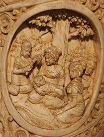 Mayadevi with her son Siddharatha This scene depicts the birth of Siddhartha, Prince of Kapilavastu in a different manner from other literary and sculptural narrations. Here Queen Mayadevi is shown seated with a baby in her lap surrounded by cauri-bearer and friends.[6]