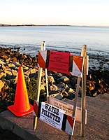 A Contra Costa county sign in Richmond Marina Bay warns of shoreline closure due to oil contamination.