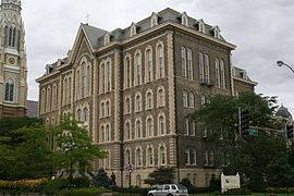 The main building of St. Ignatius College Prep in Chicago, Illinois, designed by Canadian architect Toussaint Menard, is a classic example of the style. It is one of the five extant, public buildings in Chicago that predate the Great Chicago Fire of 1871