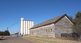 Weathered building and grain elevator in Farwell