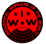 a red and black circle with the words 'Industrial Workers of the World' around the edge, and the letters IWW in the middle.