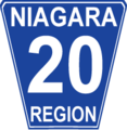 Niagara Regional Road 20 marker. While Niagara generally conforms to the standard Ontario "flowerpot" design, the markers are white-on-blue rather than the more traditional black-on-white and have rounded corners.