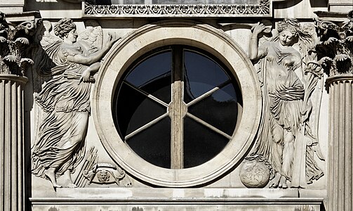 Renaissance medallion-like oculus on the west facade of the Cour Carrée of the Louvre Palace, with figures of war and peace, sculpted by Jean Goujon and designed by Pierre Lescot, 1548[7]