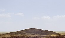 A photograph of the mound of sand that comprises the destroyed remains of the pyramid, called 'Merenre's beauty shines', which belonged to Merenre Nemtyemsaf I.