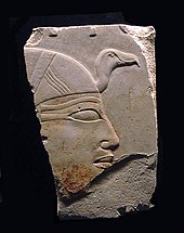 Fragment of an exquisite painted relief showing the head of a woman wearing a headdress
