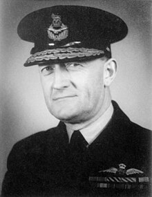 Head-and-shoulders portrait of man in dark uniform with ribbons and pilot's wings on chest, wearing peaked cap