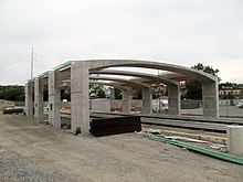 An arched concrete structure under construction