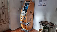 A photograph of an orange Athena Bitcoin cryptocurrency ATM