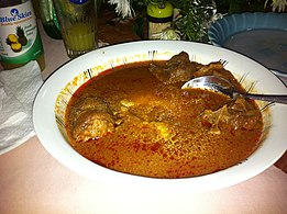 Ghanaian fufu in palmnut soup with goat