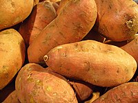Close-up view of a pile of golden sweet potato roots