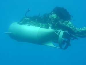 Two U.S. Marines of the MSPF operating a Diver Propulsion Device (DPD) used for stealthy approaches. [circa 1999]