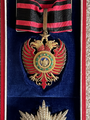 Close-up of the badge and neck ribbon of a Grand Officer.