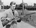 Uffe Schultz Larsens (1921-2005) with a shotgun outside a gun factory