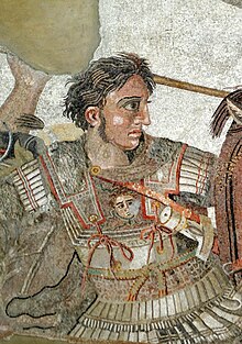 A young, clean-shaven man in heavy armour sits astride a brown horse. His breastplate bears the face of the Medusa. Although his companions wear metal helms, only his short curly dark hair separates him from a deadly blow. In his right hand he grasps the shaft of a long spear. His determined face stares in sharp profile toward the right of the picture.